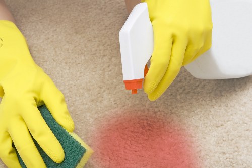 Carpet cleaner preparing equipment safely before starting work